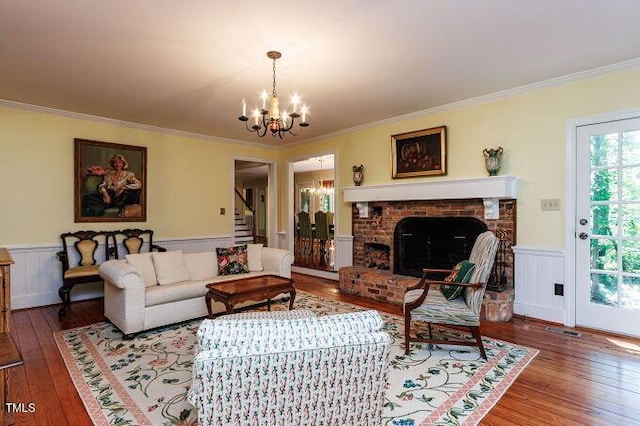 3005 Woodgreen Dr, Raleigh, NC 27607 - living area featuring a chandelier, wood-type flooring, stairs, ornamental molding, and wainscoting
