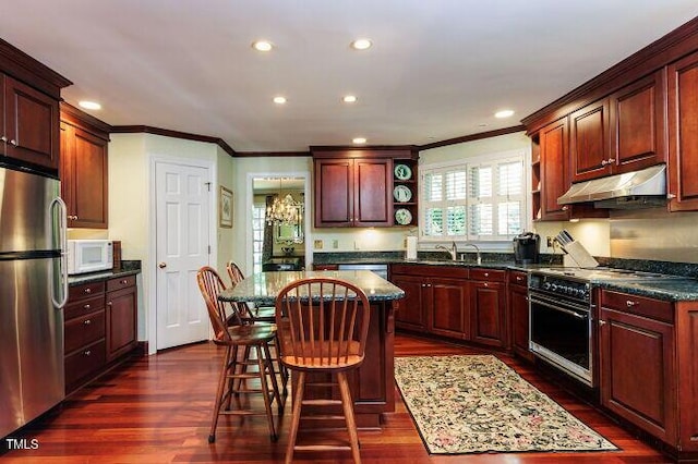 3005 Woodgreen Dr, Raleigh, NC 27607 - kitchen with appliances with stainless steel finishes, under cabinet range hood, open shelves, ornamental molding, and a kitchen island