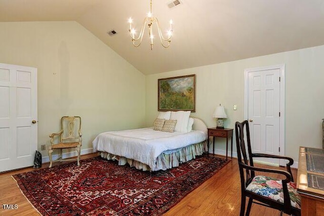 3005 Woodgreen Dr, Raleigh, NC 27607 - bedroom with a chandelier, wood finished floors, and lofted ceiling