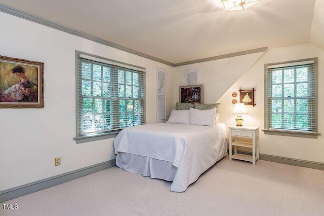 3005 Woodgreen Dr, Raleigh, NC 27607 - bedroom with multiple windows, light colored carpet, vaulted ceiling, and crown molding