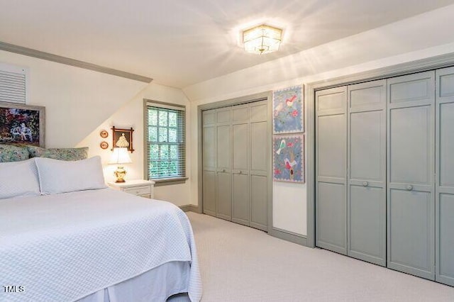 3005 Woodgreen Dr, Raleigh, NC 27607 - bedroom with light colored carpet, lofted ceiling, and two closets