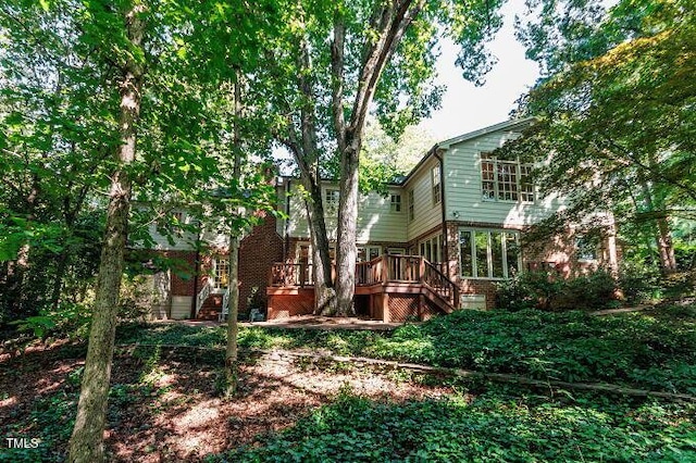 3005 Woodgreen Dr, Raleigh, NC 27607 - back of property with a wooden deck, brick siding, and stairway
