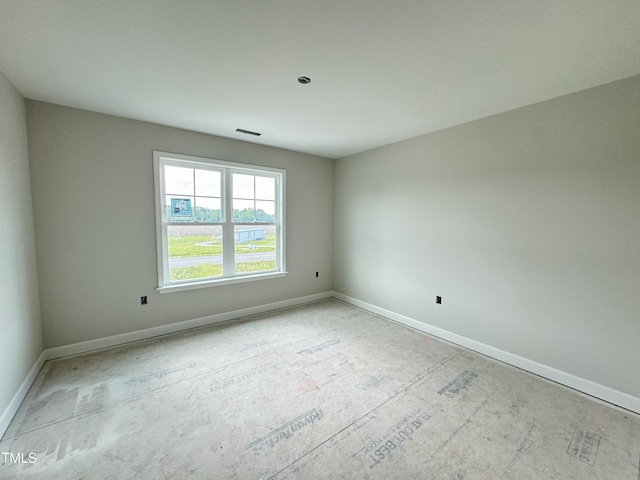 unfurnished room featuring baseboards