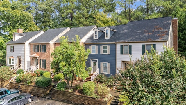 3111 Coachmans Way, Durham, NC 27705 - view of property featuring a chimney and uncovered parking