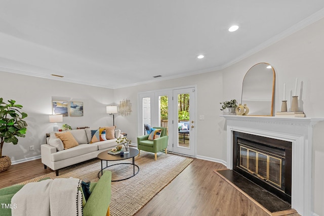 3111 Coachmans Way, Durham, NC 27705 - living area featuring crown molding, a glass covered fireplace, wood finished floors, baseboards, and recessed lighting