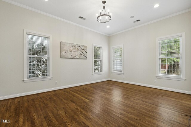 spare room featuring an inviting chandelier, visible vents, and a wealth of natural light