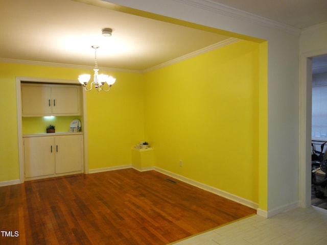 unfurnished dining area with baseboards, dark wood-style floors, a chandelier, and crown molding