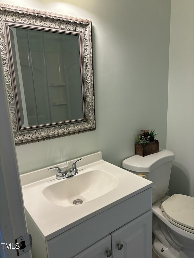 bathroom featuring toilet and vanity