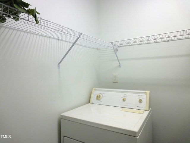 clothes washing area with washer / dryer