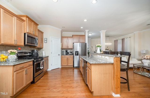 1030 Thoughtful Spot Ln, Durham, NC 27703 - kitchen with stainless steel appliances, a breakfast bar, a sink, decorative backsplash, and ornamental molding