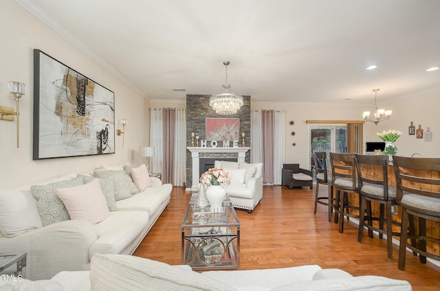 1030 Thoughtful Spot Ln, Durham, NC 27703 - living area featuring a chandelier, ornamental molding, light wood-style floors, and a large fireplace