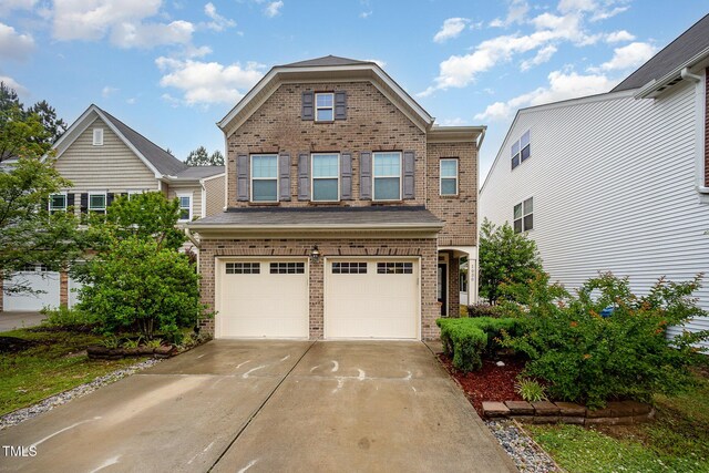 1030 Thoughtful Spot Ln, Durham, NC 27703 - view of front of property featuring brick siding, a garage, and driveway