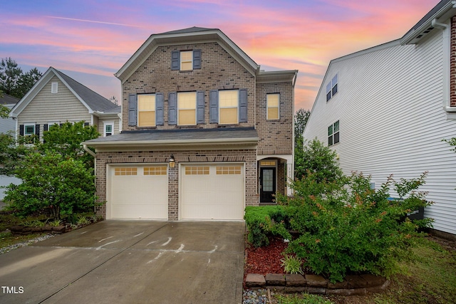 1030 Thoughtful Spot Ln, Durham, NC 27703 - view of front of house with brick siding, an attached garage, and concrete driveway