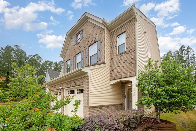 1030 Thoughtful Spot Ln, Durham, NC 27703 - view of home's exterior featuring brick siding and a garage