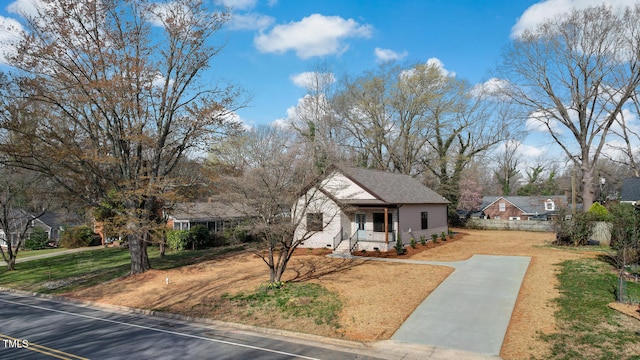 view of front of property with covered porch and a front yard