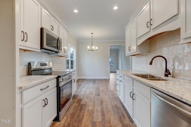 kitchen featuring a sink, white cabinetry, wood finished floors, and appliances with stainless steel finishes