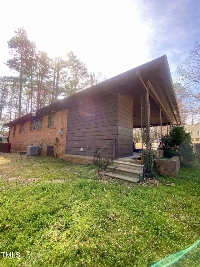 back of house with crawl space, central air condition unit, and a yard