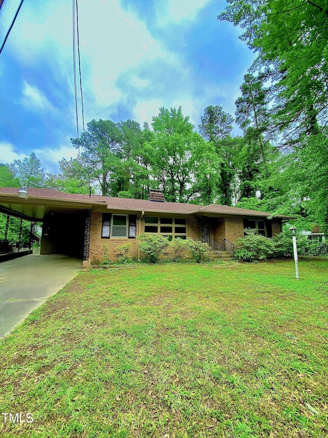 1115 Park Ave, Henderson, NC 27536 - ranch-style house featuring a front lawn, a carport, brick siding, and driveway