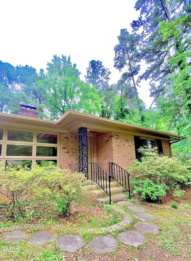 1115 Park Ave, Henderson, NC 27536 - view of front of house featuring brick siding and a chimney