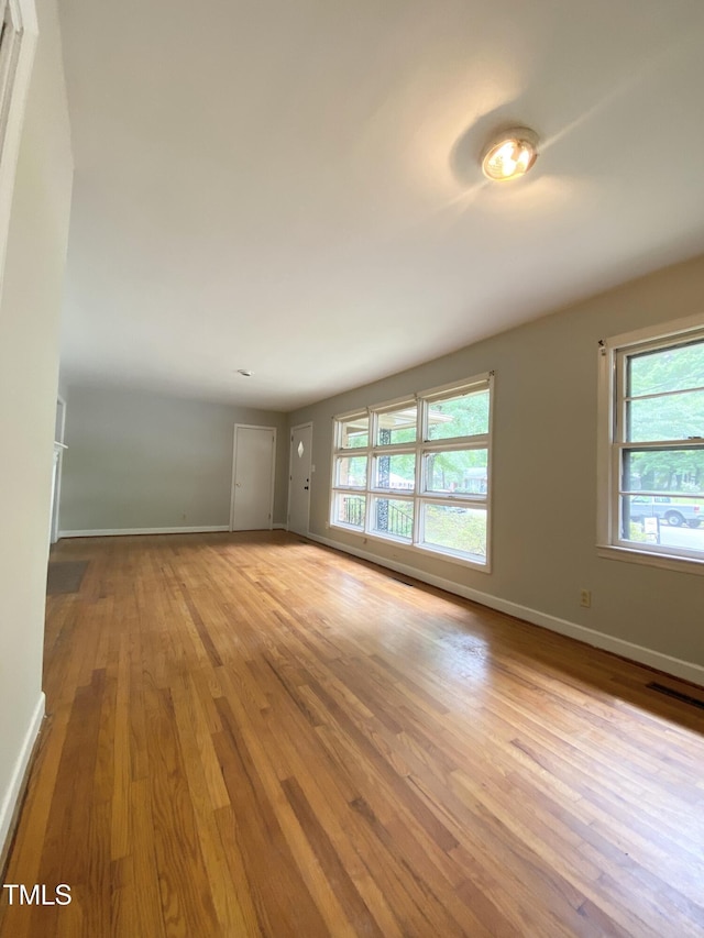 1115 Park Ave, Henderson, NC 27536 - spare room featuring wood finished floors and baseboards