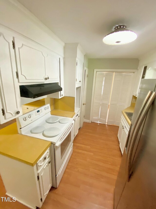 1115 Park Ave, Henderson, NC 27536 - kitchen with white electric stove, under cabinet range hood, white cabinetry, and light wood finished floors