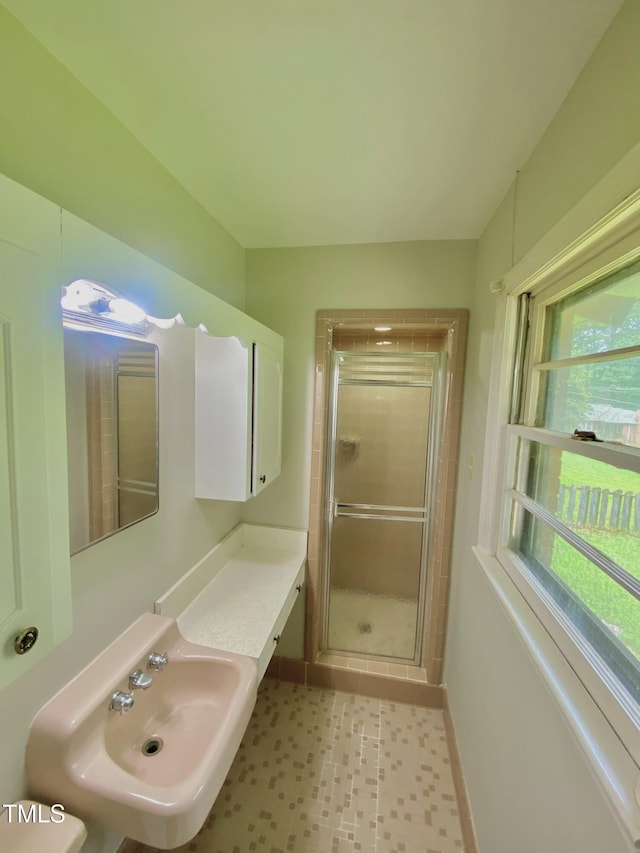 1115 Park Ave, Henderson, NC 27536 - bathroom featuring a stall shower, a sink, baseboards, and tile patterned floors
