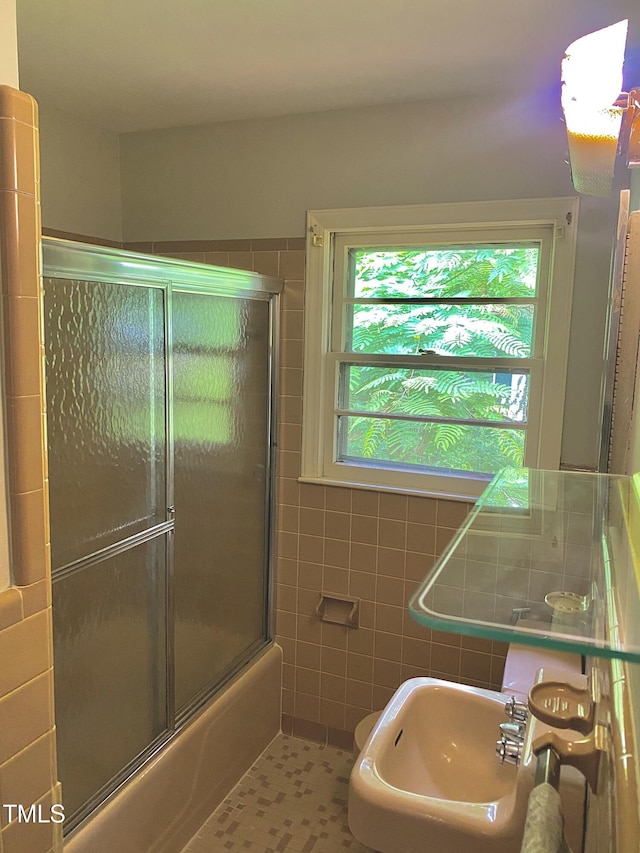 1115 Park Ave, Henderson, NC 27536 - full bath with a sink, tile walls, enclosed tub / shower combo, and tile patterned floors