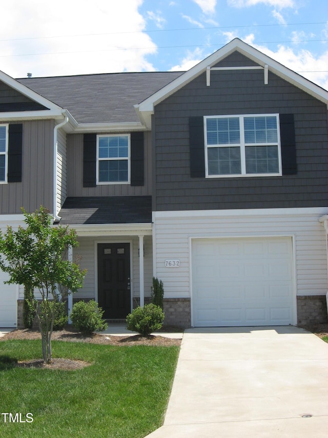 view of front of house featuring driveway, a garage, board and batten siding, a shingled roof, and a front lawn