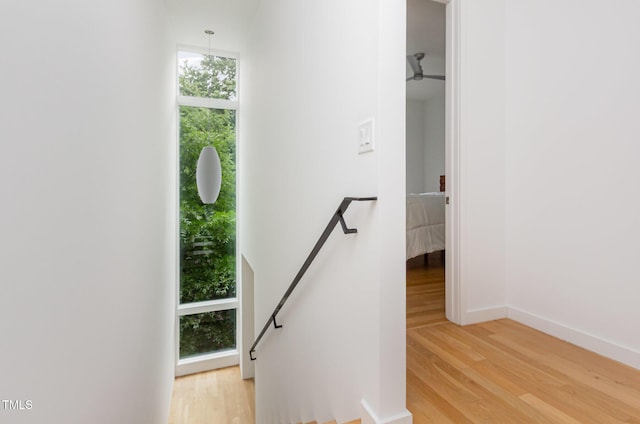 stairs featuring wood finished floors and baseboards