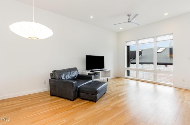 sitting room with light wood finished floors, ceiling fan, recessed lighting, and baseboards