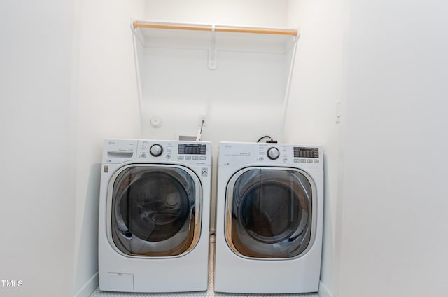 laundry area featuring washing machine and dryer and baseboards