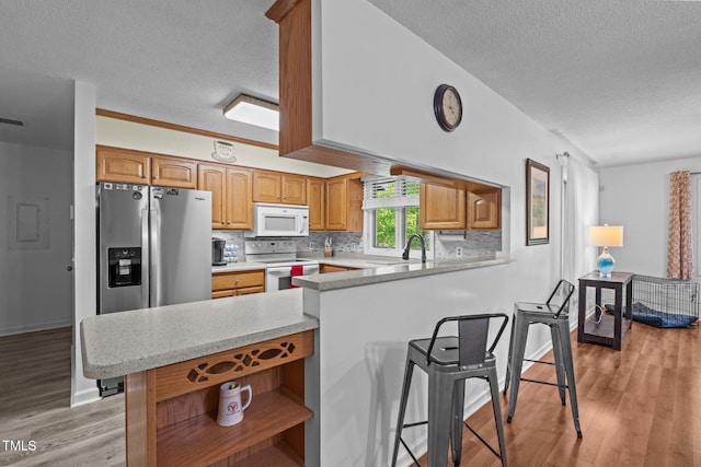 1801 Irish Blvd, Sanford, NC 27332 - kitchen with a peninsula, a textured ceiling, white appliances, open shelves, and light countertops