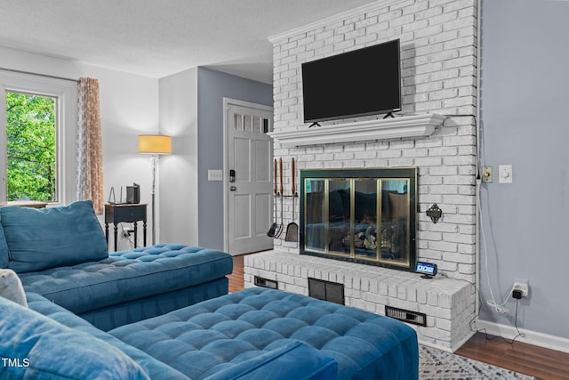 1801 Irish Blvd, Sanford, NC 27332 - living room with baseboards, a brick fireplace, wood finished floors, and a textured ceiling