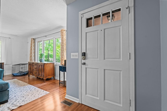 1801 Irish Blvd, Sanford, NC 27332 - entrance foyer featuring baseboards, wood finished floors, visible vents, and a textured ceiling