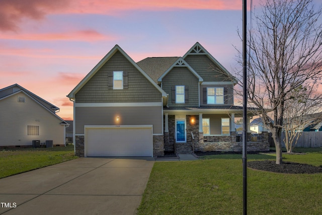5824 Lady Way, Hope Mills, NC 28348 - craftsman-style house with stone siding, concrete driveway, fence, a front lawn, and a garage