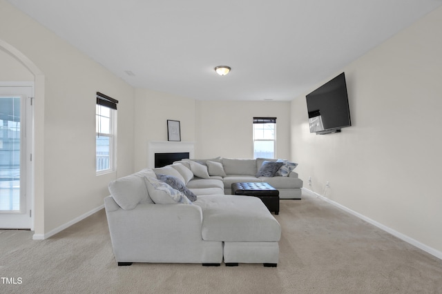 5824 Lady Way, Hope Mills, NC 28348 - living room featuring baseboards, a fireplace, arched walkways, and carpet flooring