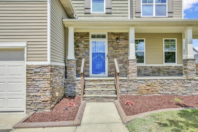 5824 Lady Way, Hope Mills, NC 28348 - property entrance featuring stone siding, covered porch, and a garage