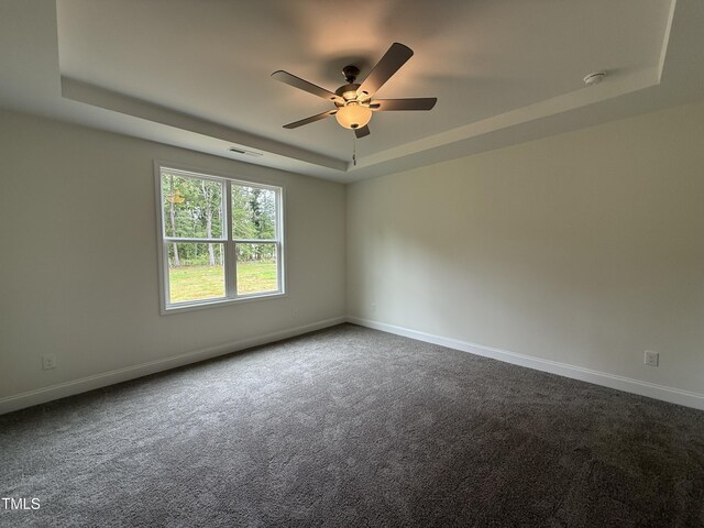 274 Longbow Dr, Middlesex, NC 27557 - empty room with a raised ceiling, ceiling fan, dark carpet, and a smoke detector