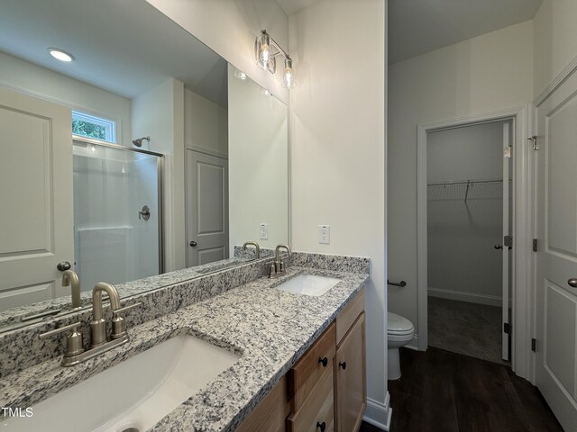 274 Longbow Dr, Middlesex, NC 27557 - bathroom with a stall shower, wood finished floors, double vanity, and a spacious closet