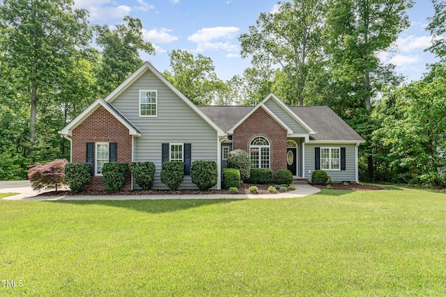 315 Copper Ridge Dr, Sanford, NC 27330 - view of front of property featuring a front yard, a shingled roof, and brick siding