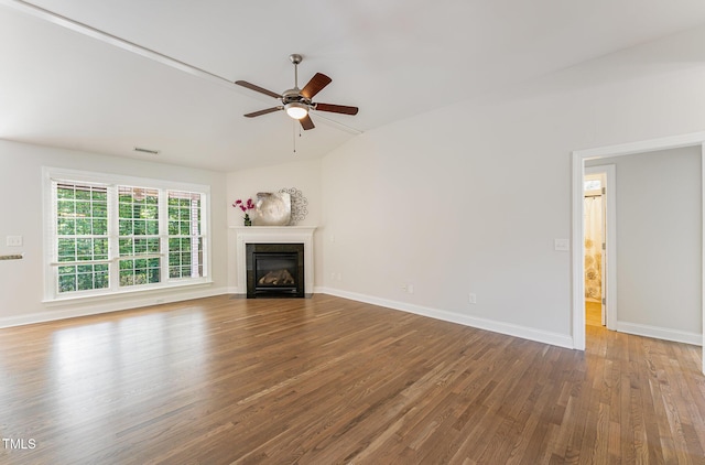 315 Copper Ridge Dr, Sanford, NC 27330 - unfurnished living room with wood finished floors, a glass covered fireplace, baseboards, a ceiling fan, and lofted ceiling