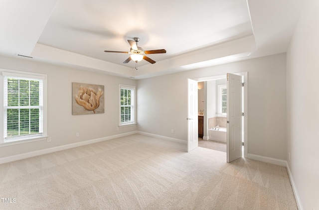315 Copper Ridge Dr, Sanford, NC 27330 - unfurnished bedroom with multiple windows, a raised ceiling, baseboards, and light carpet