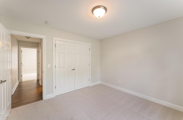315 Copper Ridge Dr, Sanford, NC 27330 - unfurnished bedroom with baseboards, a closet, and carpet flooring
