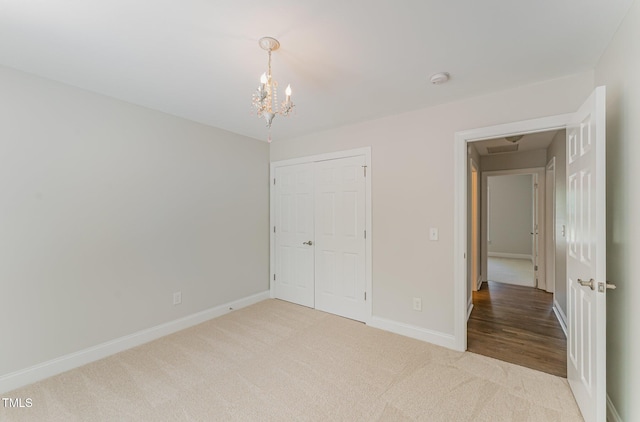 315 Copper Ridge Dr, Sanford, NC 27330 - unfurnished bedroom with a closet, an inviting chandelier, light carpet, and baseboards