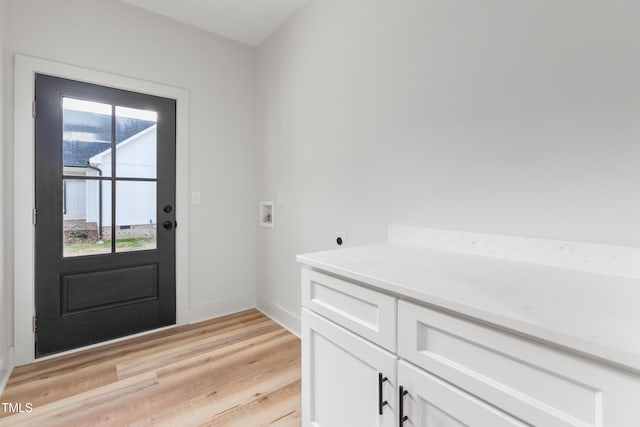entrance foyer featuring light wood-style flooring, plenty of natural light, and baseboards