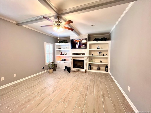 unfurnished living room featuring a ceiling fan, beamed ceiling, light wood finished floors, and a fireplace