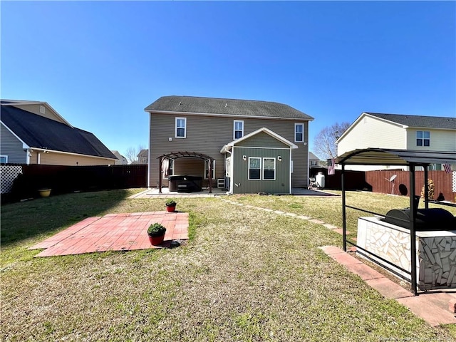 back of house featuring a patio, a yard, a pergola, and a fenced backyard