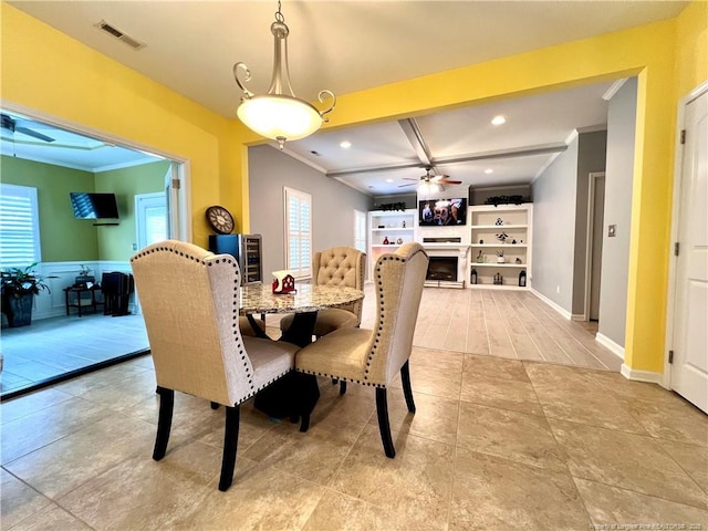 dining area with a fireplace, visible vents, a ceiling fan, and ornamental molding