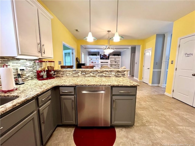 kitchen featuring a peninsula, gray cabinets, light stone counters, and decorative backsplash