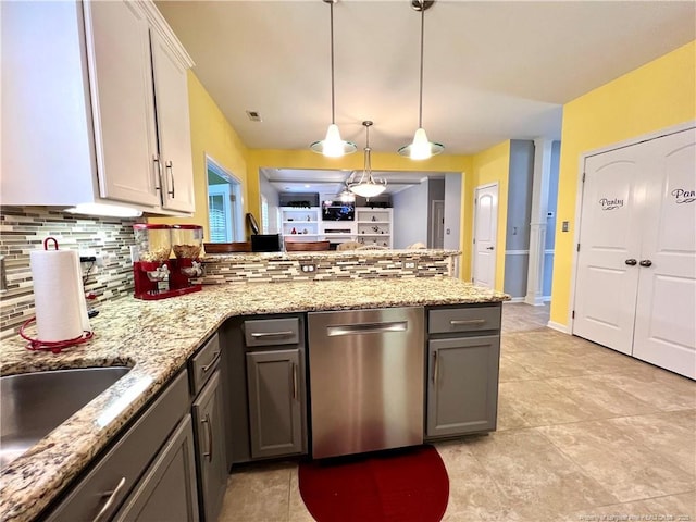 kitchen with stainless steel dishwasher, tasteful backsplash, a peninsula, and gray cabinets